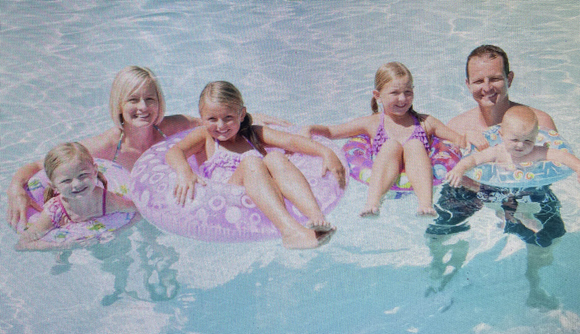 Family with small children in the swimming pool